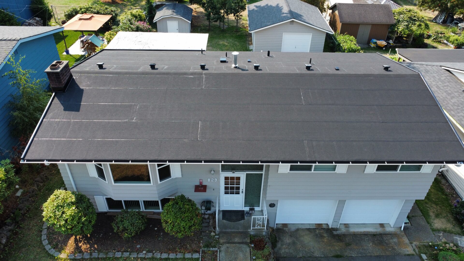 Ridge vent and soffit vent installation on a Seattle roof replacement, showing the continuous airflow path from eaves to peak